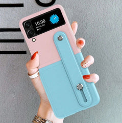 Pink/Light Blue Color Block Folding Bracelet Stand Extendable Spray Painted Dual-Tone Stitching Frosted Texture Lens Protection Stylish Foldable Phone Case Anti-Fall Phone Cover Compatible With Samsung Galaxy Z Flip 4